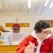 Diverse group of college students focused on studying in a university classroom setting.