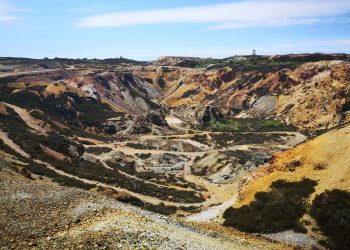 Vibrant aerial view of Parys Mountain's historic copper mine in Wales showcasing rugged geological formations.