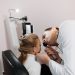 A doctor examines a young girl's ear during a medical appointment in a clinic.