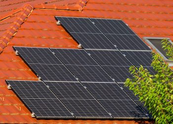Close-up of solar panels on a red tiled roof in Croatia, highlighting renewable energy.