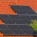 Close-up of solar panels on a red tiled roof in Croatia, highlighting renewable energy.