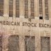 Facade of the American Stock Exchange Building in New York City during spring with blooming trees.