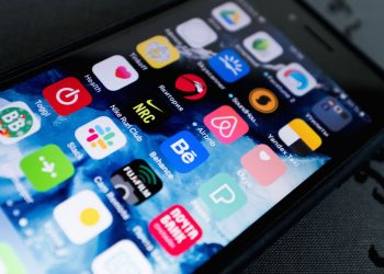 Detailed view of smartphone displaying multiple app icons on screen, highlighting technology use.