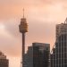 A captivating view of Sydney Tower among modern skyscrapers during sunset, showcasing urban architecture.