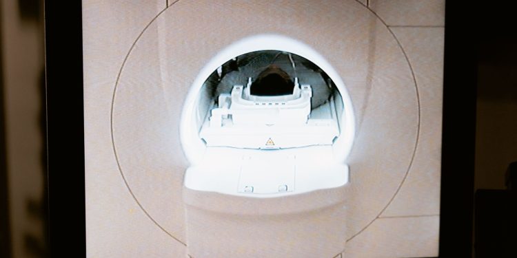 Close-up of an MRI scanner displayed on a monitor in a medical clinic.