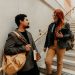 Adult students discussing in a university building on a marble staircase in Buenos Aires.
