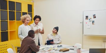 A diverse group of professionals having a collaborative meeting in a modern office space.