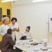 A diverse group of professionals having a collaborative meeting in a modern office space.