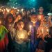 A diverse group of people holding candles at a nighttime vigil outdoors.