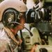 A soldier in uniform operates military equipment inside a vehicle, showcasing modern military technology.