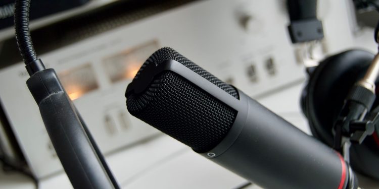 Close-up shot of a microphone in a studio setting, ideal for audio recording.