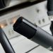 Close-up shot of a microphone in a studio setting, ideal for audio recording.
