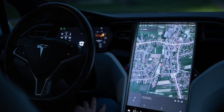 Explore the advanced touchscreen navigation in a modern electric vehicle's sleek interior at night.