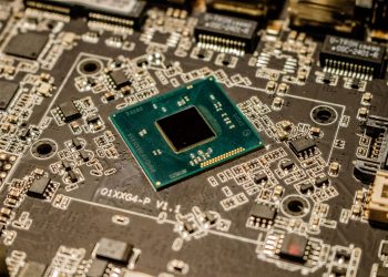 Detailed view of a microchip on a printed circuit board, showcasing electronic components.