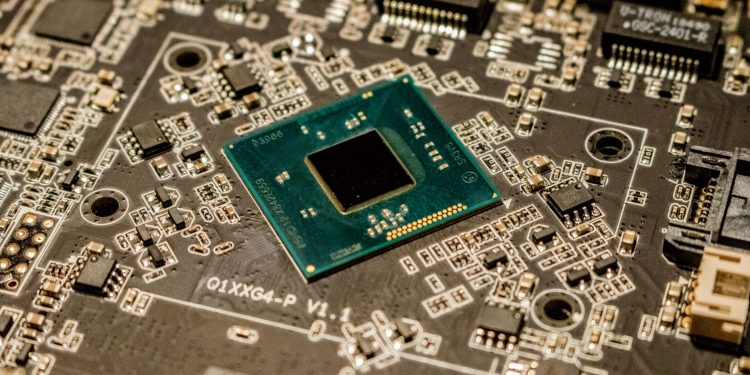 Detailed view of a microchip on a printed circuit board, showcasing electronic components.