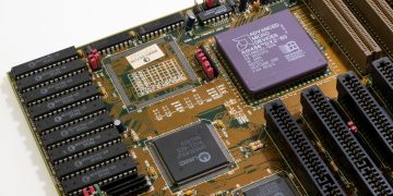 Detailed close-up image of a vintage motherboard showcasing microprocessor and components.