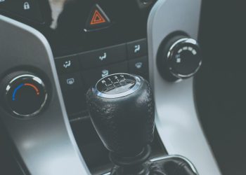 Detailed view of a manual gear shift knob and car console interior.