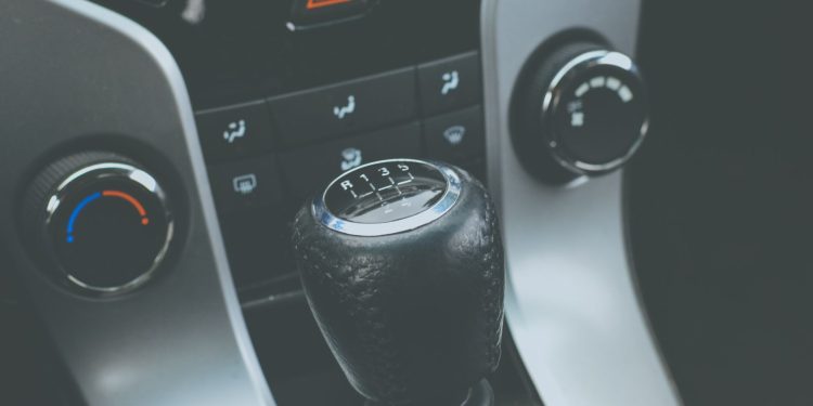 Detailed view of a manual gear shift knob and car console interior.