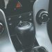 Detailed view of a manual gear shift knob and car console interior.