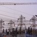 Construction site with cranes and power lines in Mumbai during evening hours.
