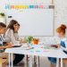 Students and teacher interacting in a bright, colorful classroom setting.