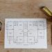Top view of set of plan of room with tape measure and pen for work for architect with cup with coffee on wooden table in soft daylight