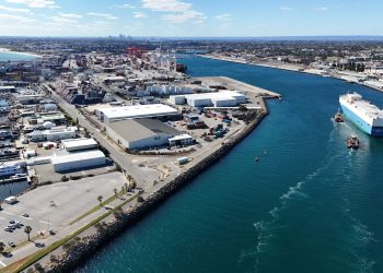 Aerial shot of Fremantle Port in Western Australia, showcasing container ships and industrial landscape.