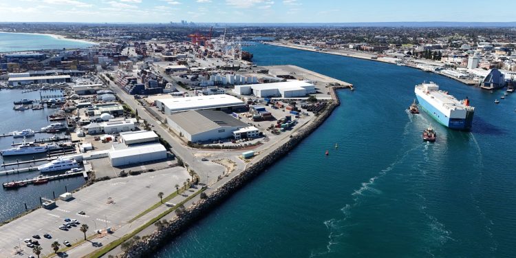 Aerial shot of Fremantle Port in Western Australia, showcasing container ships and industrial landscape.
