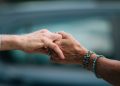 A heartfelt image of two elderly individuals holding hands, symbolizing love and support.