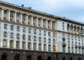 Illuminated government building in Sofia, showing classic architectural design under a twilight sky.