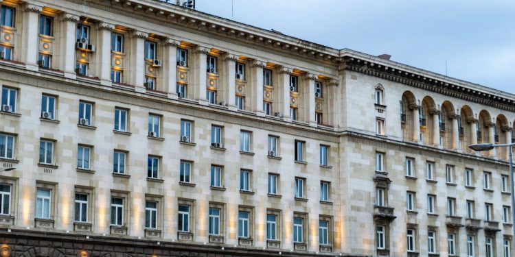 Illuminated government building in Sofia, showing classic architectural design under a twilight sky.