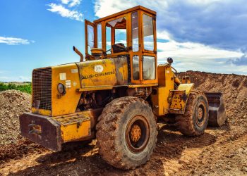 A yellow bulldozer on a construction site, highlighting heavy machinery in action.