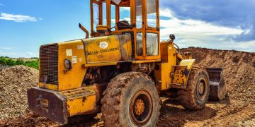 A yellow bulldozer on a construction site, highlighting heavy machinery in action.