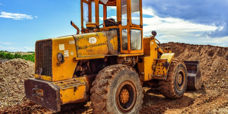 A yellow bulldozer on a construction site, highlighting heavy machinery in action.