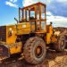 A yellow bulldozer on a construction site, highlighting heavy machinery in action.