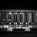 Monochrome image showcasing the National Library of Australia with illuminating fountains at night.