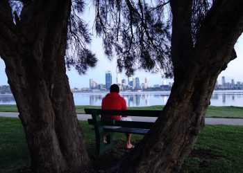 Man Watching Perth City Skyline Across Lake.jpg