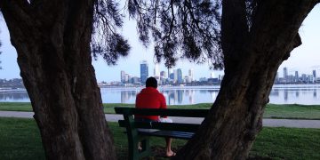 Man Watching Perth City Skyline Across Lake.jpg