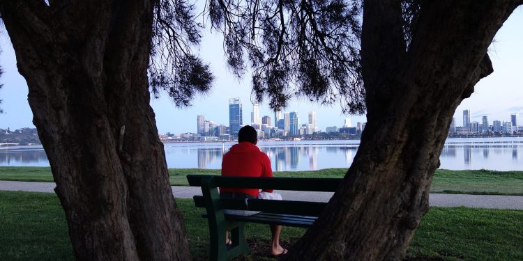 Man Watching Perth City Skyline Across Lake.jpg
