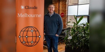 Rye Smith with the Claude Melbourne banner