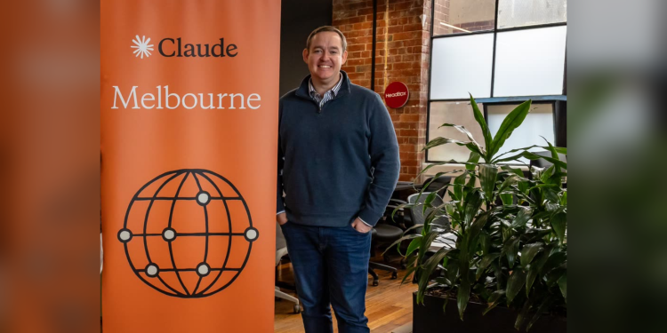 Rye Smith with the Claude Melbourne banner