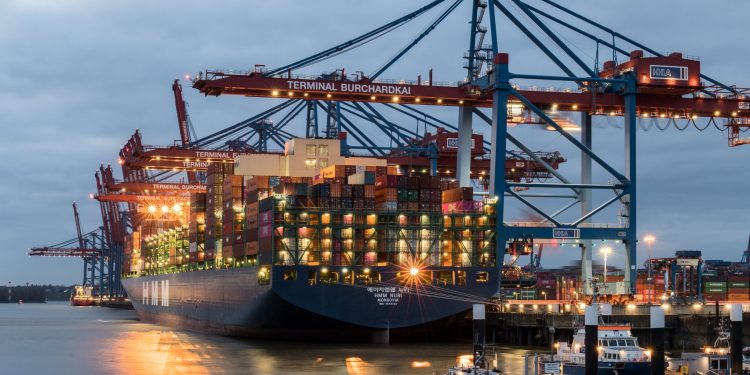 Container ships moored at Terminal Burchardkai in Hamburg, Germany during evening hours.