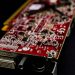 Detailed close-up of a red circuit board showcasing electronic components.