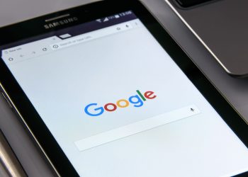 Close-up of a tablet displaying Google's search screen, emphasizing technology and internet browsing.