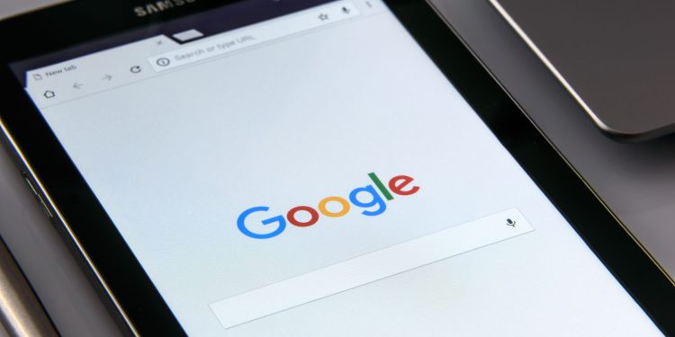 Close-up of a tablet displaying Google's search screen, emphasizing technology and internet browsing.