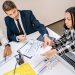 Business professionals engaging in a collaborative meeting with charts and documents.