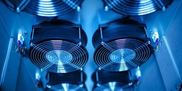 Close-up of cooling fans in a server room, showcasing technology and efficiency.