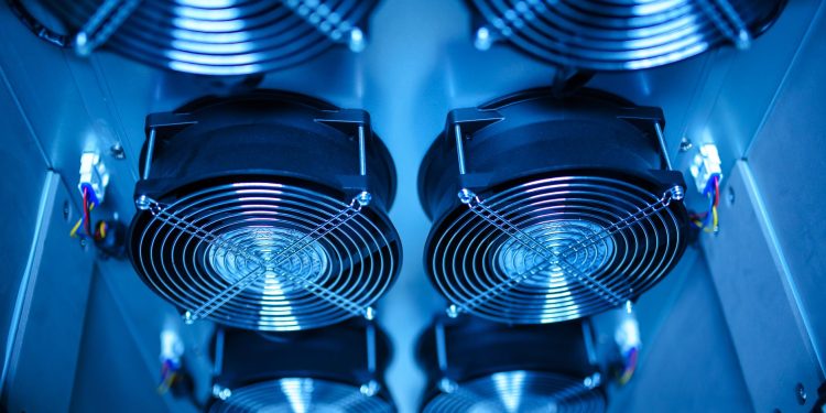 Close-up of cooling fans in a server room, showcasing technology and efficiency.