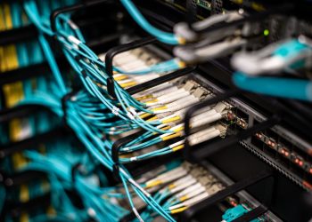 Numerous wires and cables mounted into server patch panel in modern data center