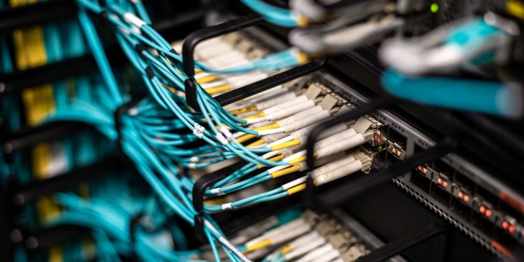 Numerous wires and cables mounted into server patch panel in modern data center